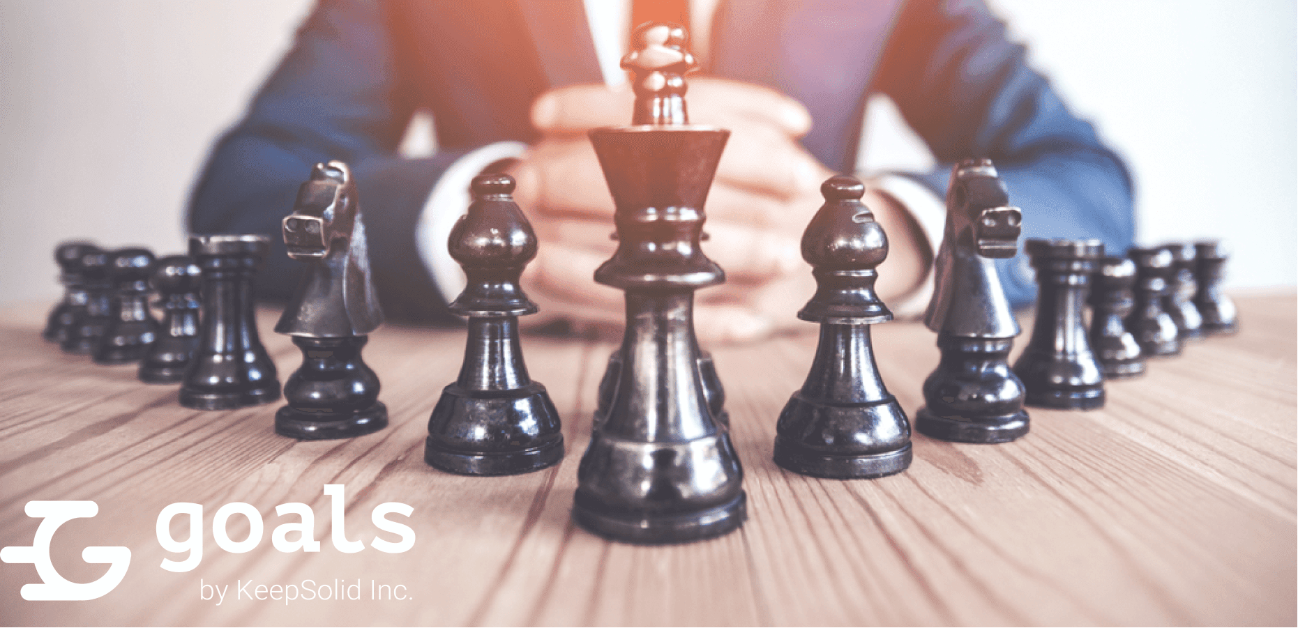 Retro style image of a businessman with clasped hands planning strategy with chess figures on an old wooden table, concept of strategic management